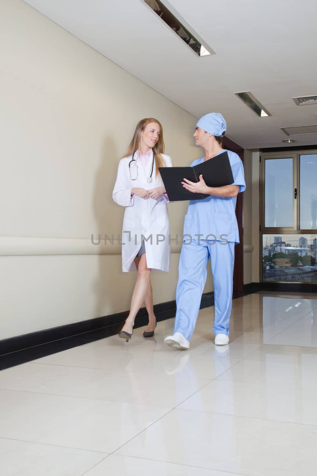 Doctor and nurse reading information from database