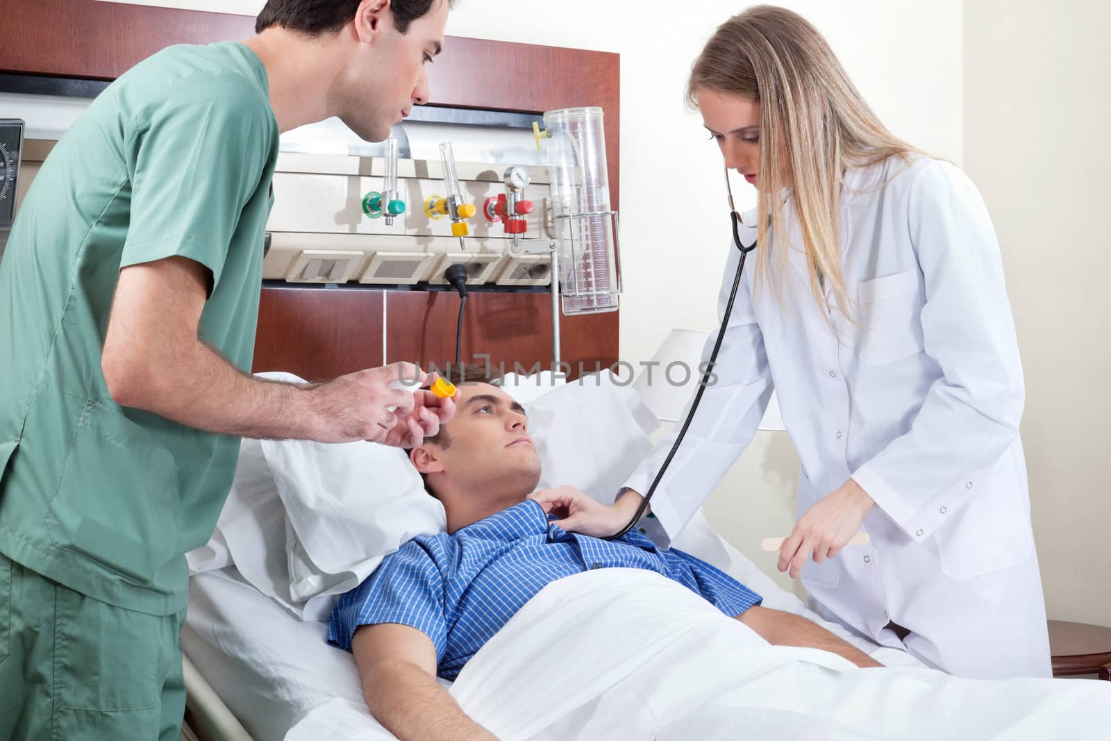 Female doctor checking young patient in hospital