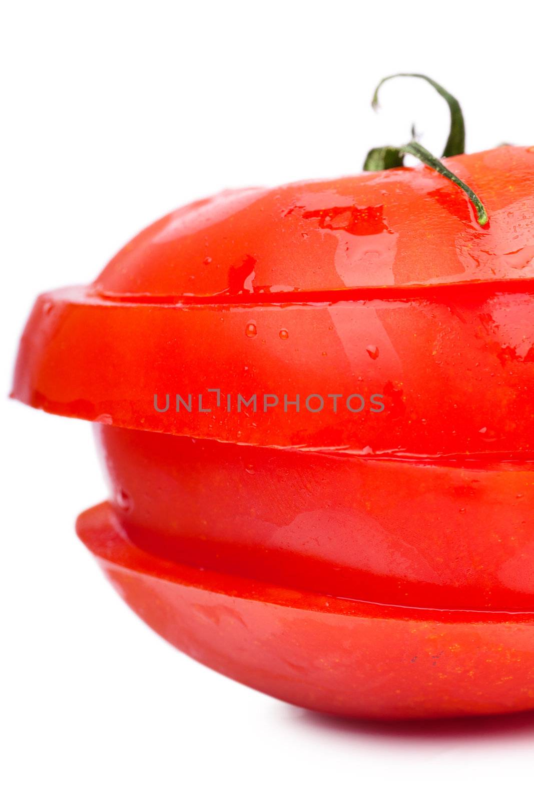 Sections of fresh ripe red tomato isolated over white background. Diet concept