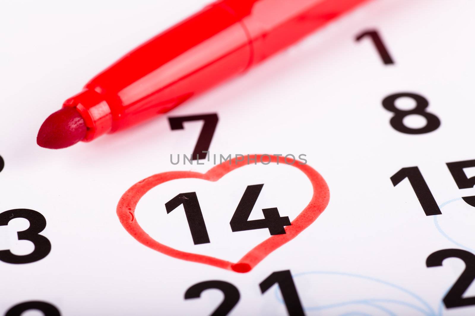 Sheet of wall calendar with red heart shaped mark on Valentines day