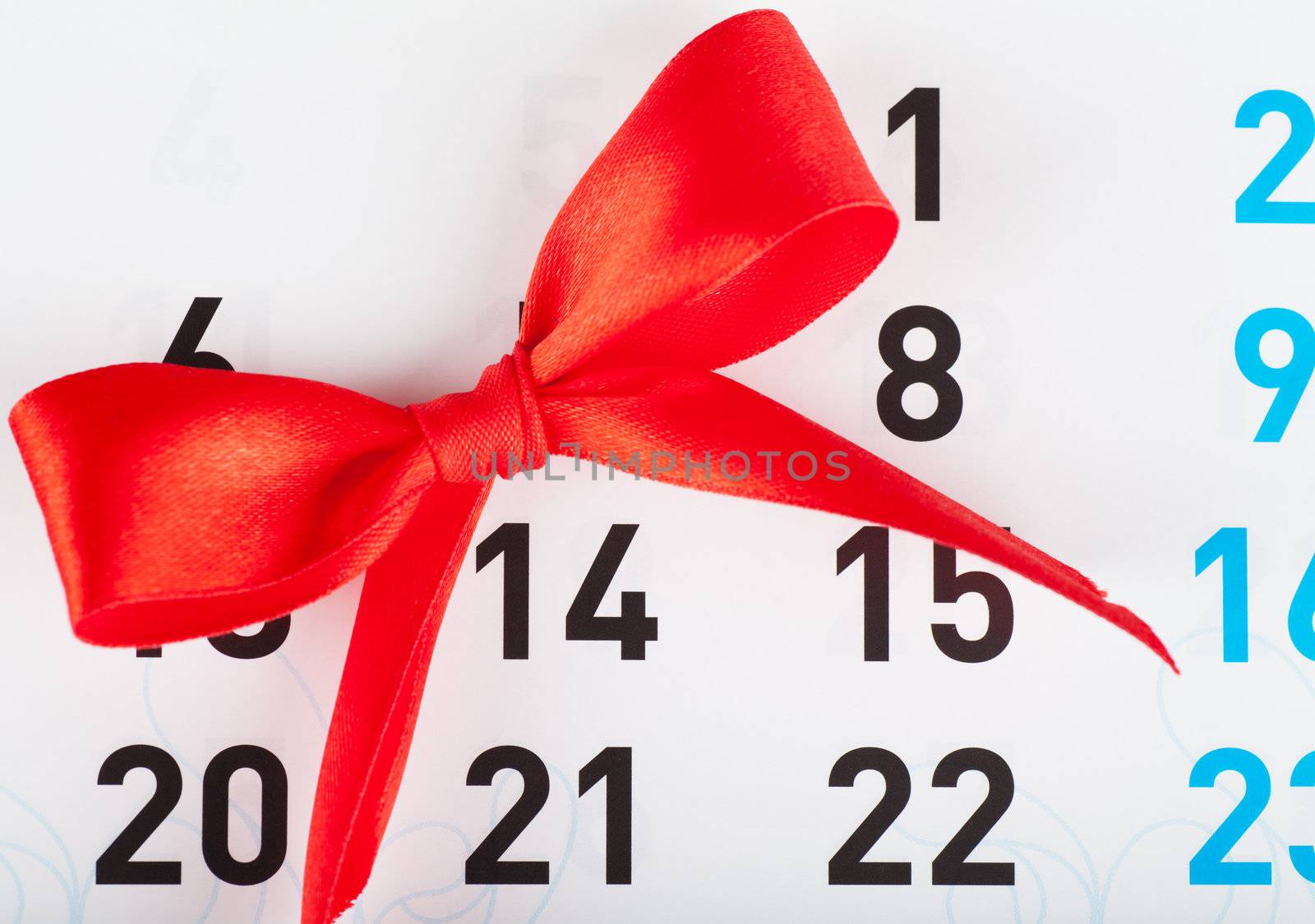 Sheet of wall calendar with red bow on Valentines day