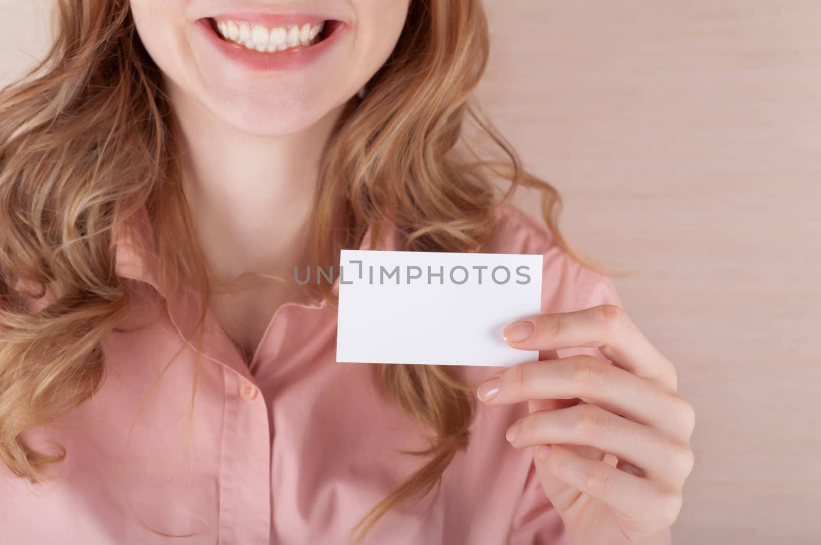 Image of smiling business woman holding her visiting card