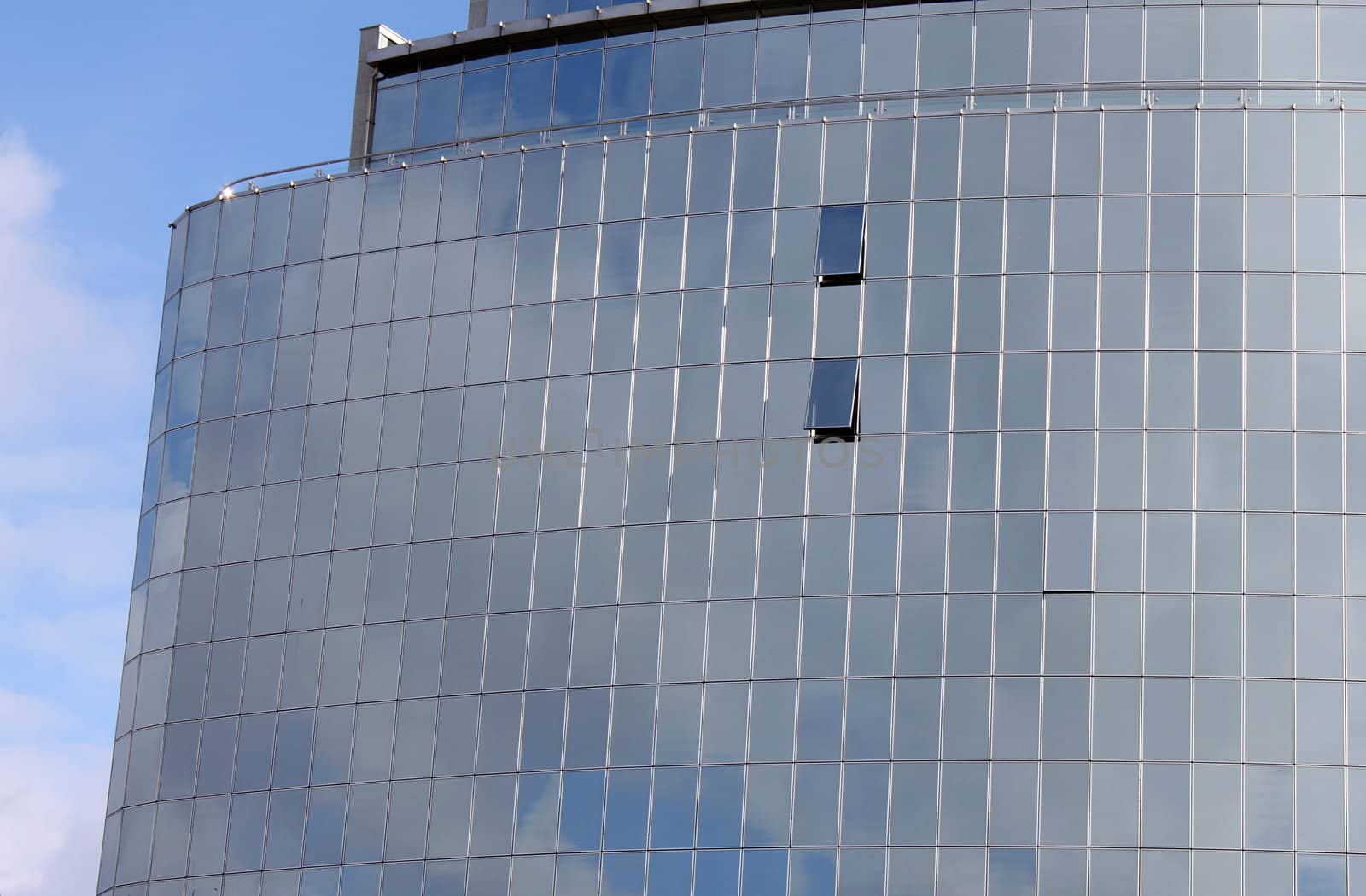 reflection of sky in windows of modern building