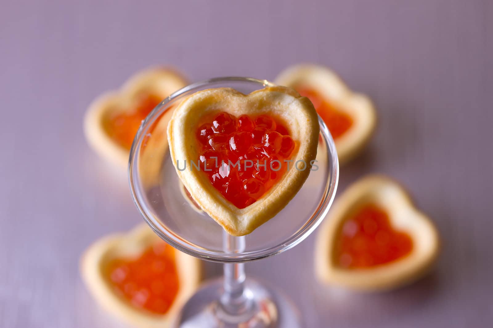 Tartlets with heart-shaped eggs on a glass base