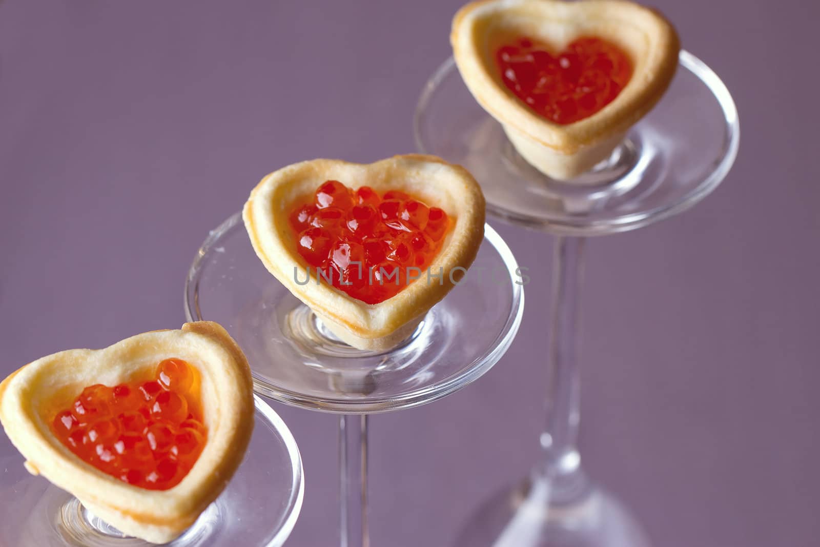 Tartlets with heart-shaped eggs on a glass base