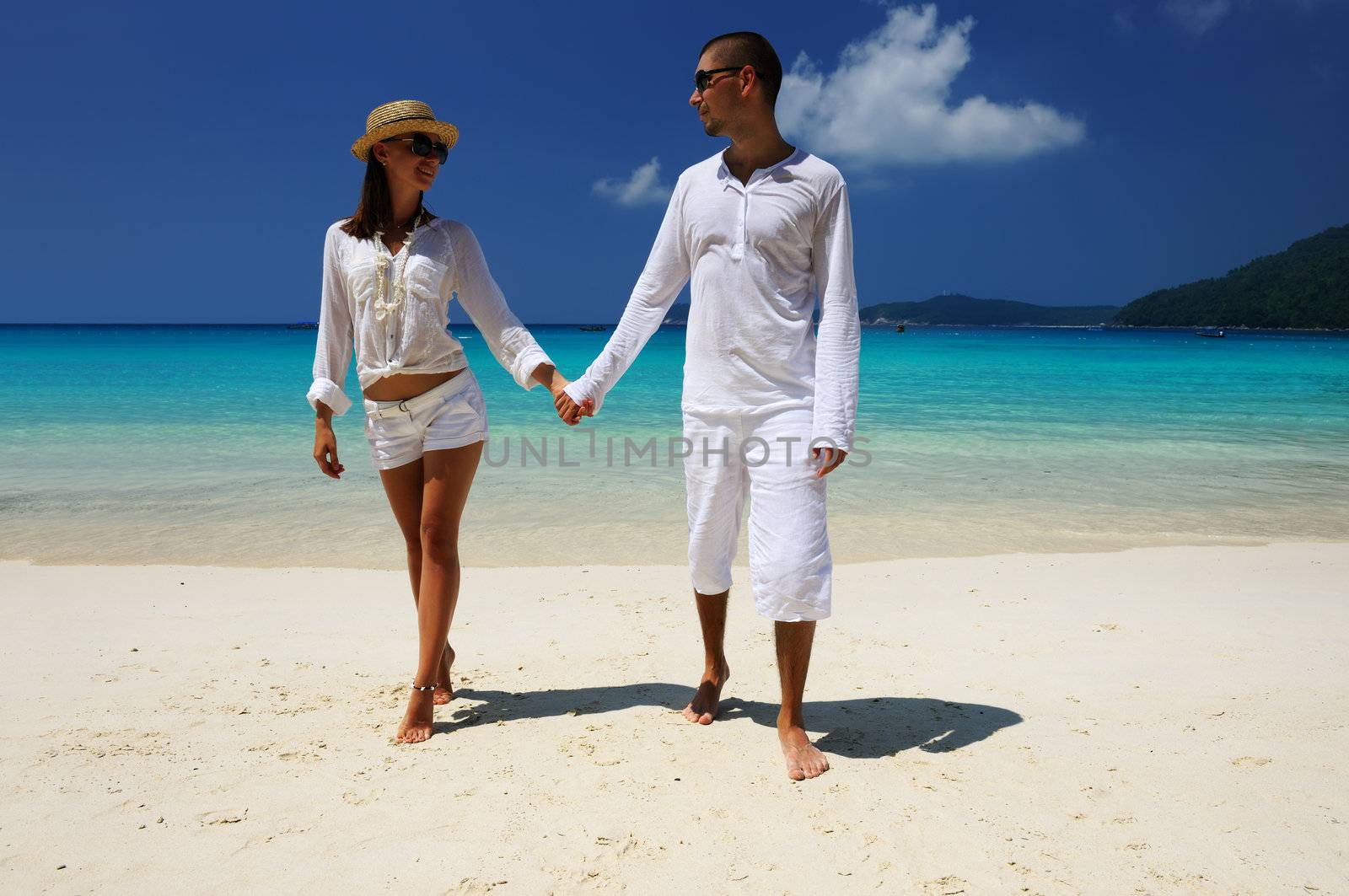 Couple in white on a tropical beach