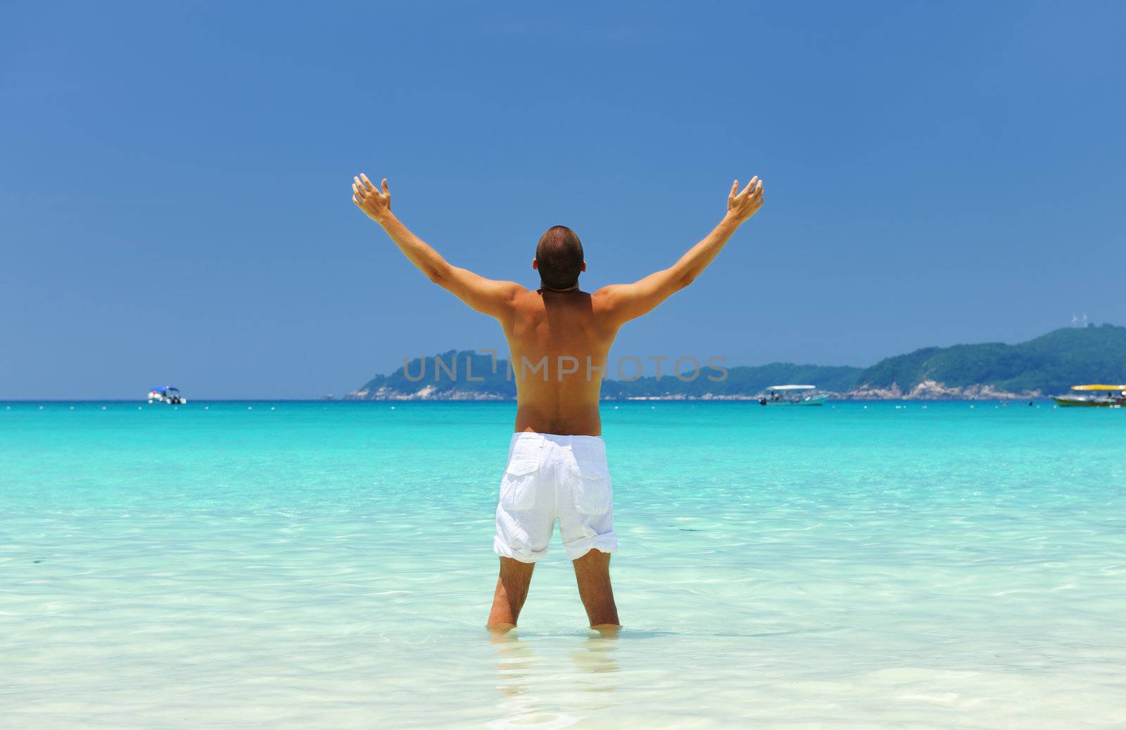 Man in white at tropical beach