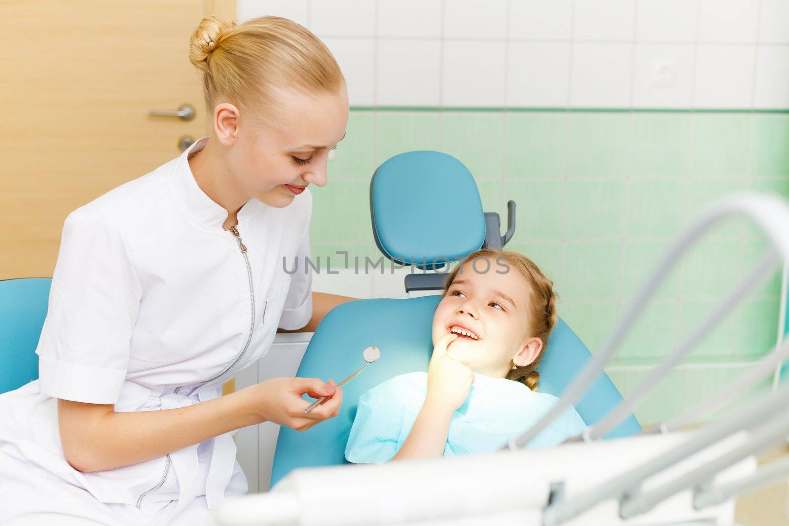 Little girl visiting dentist by sergey_nivens