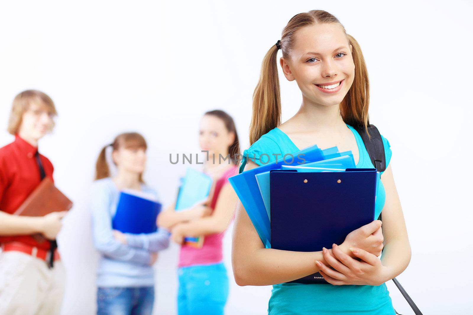 Young female student at college with books