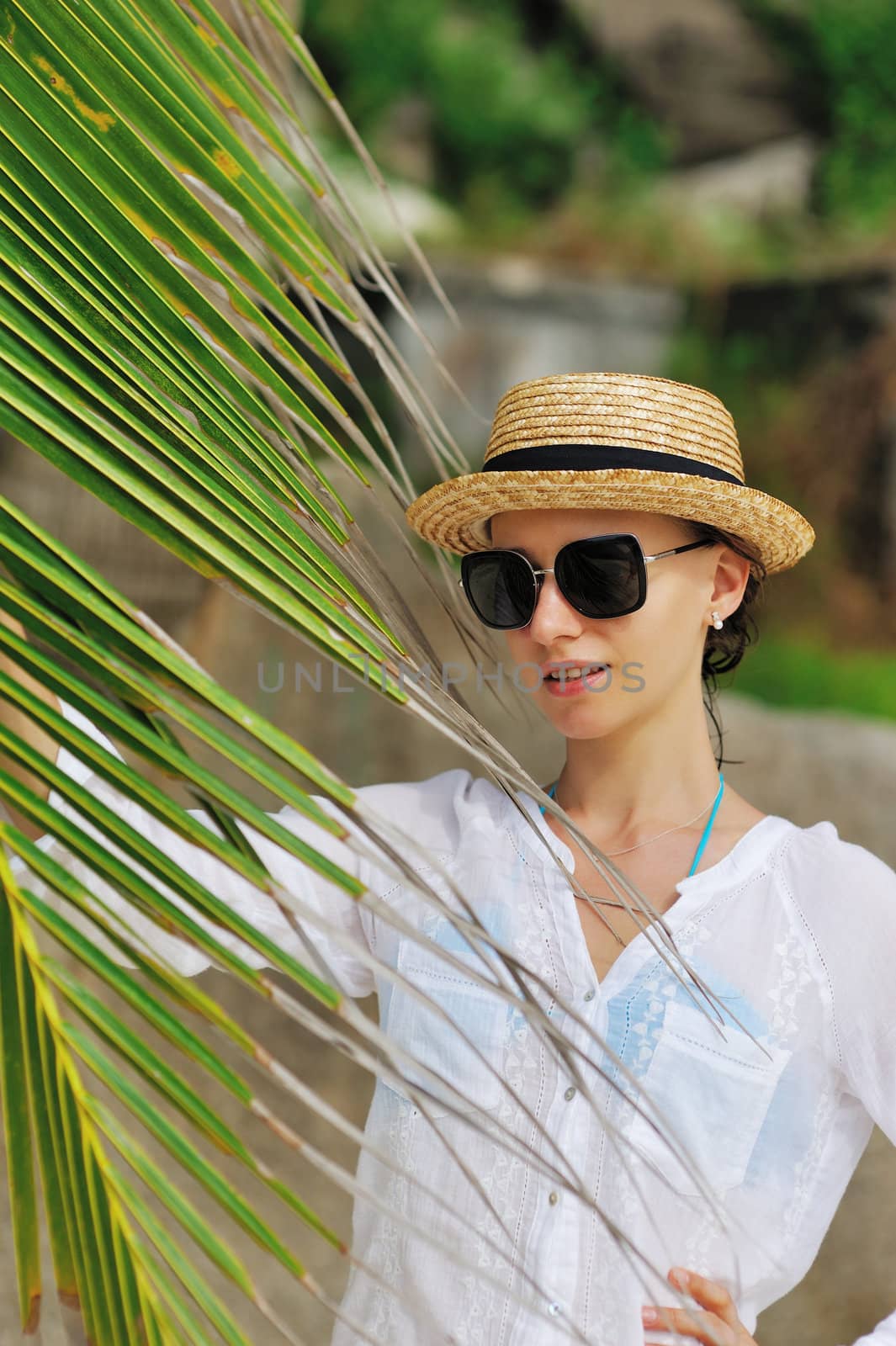 Woman in sunglasses near palm tree by haveseen