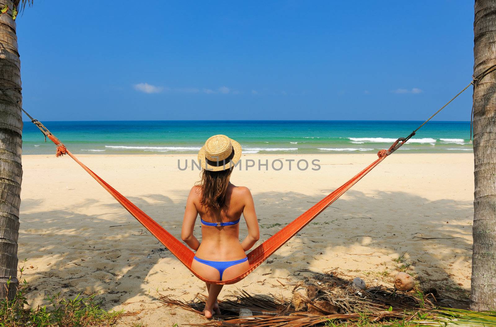 Woman in hammock on beach by haveseen