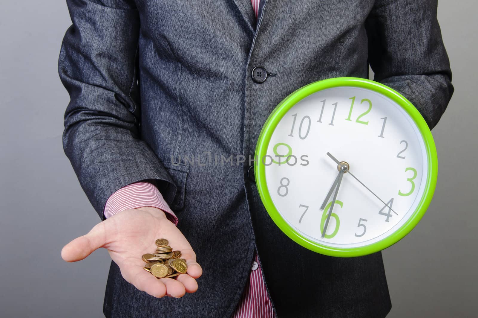 An image of young businessmen holding money and watch in his hands