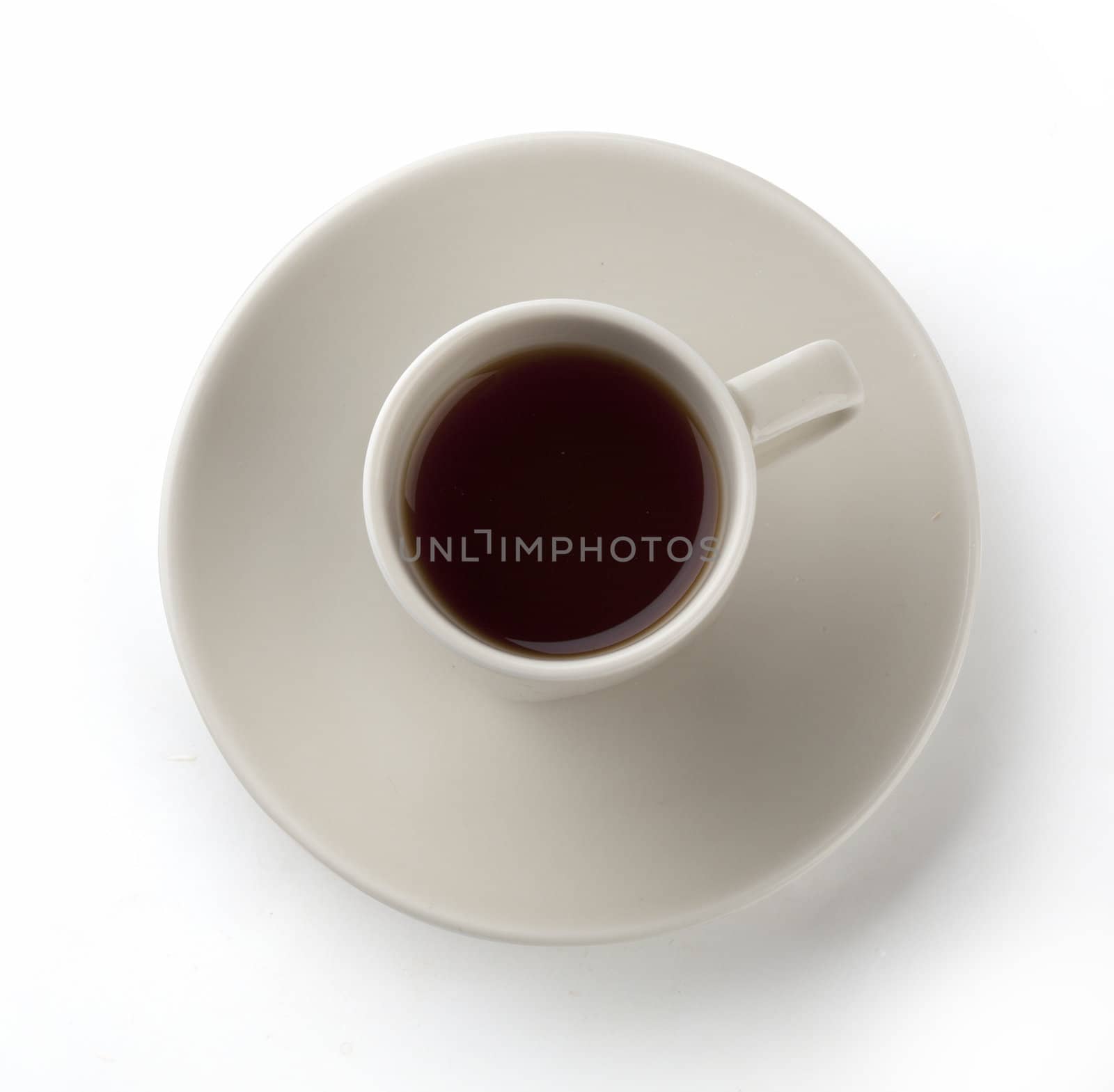 Isolated beige cup of coffee on the saucer