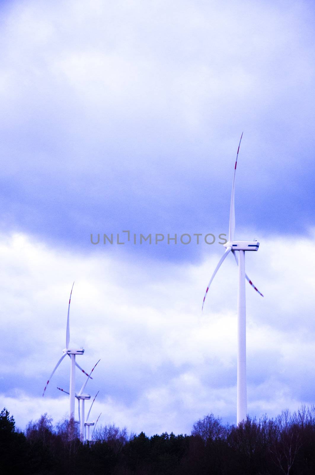 An image of windturbine generator over cloudy sky