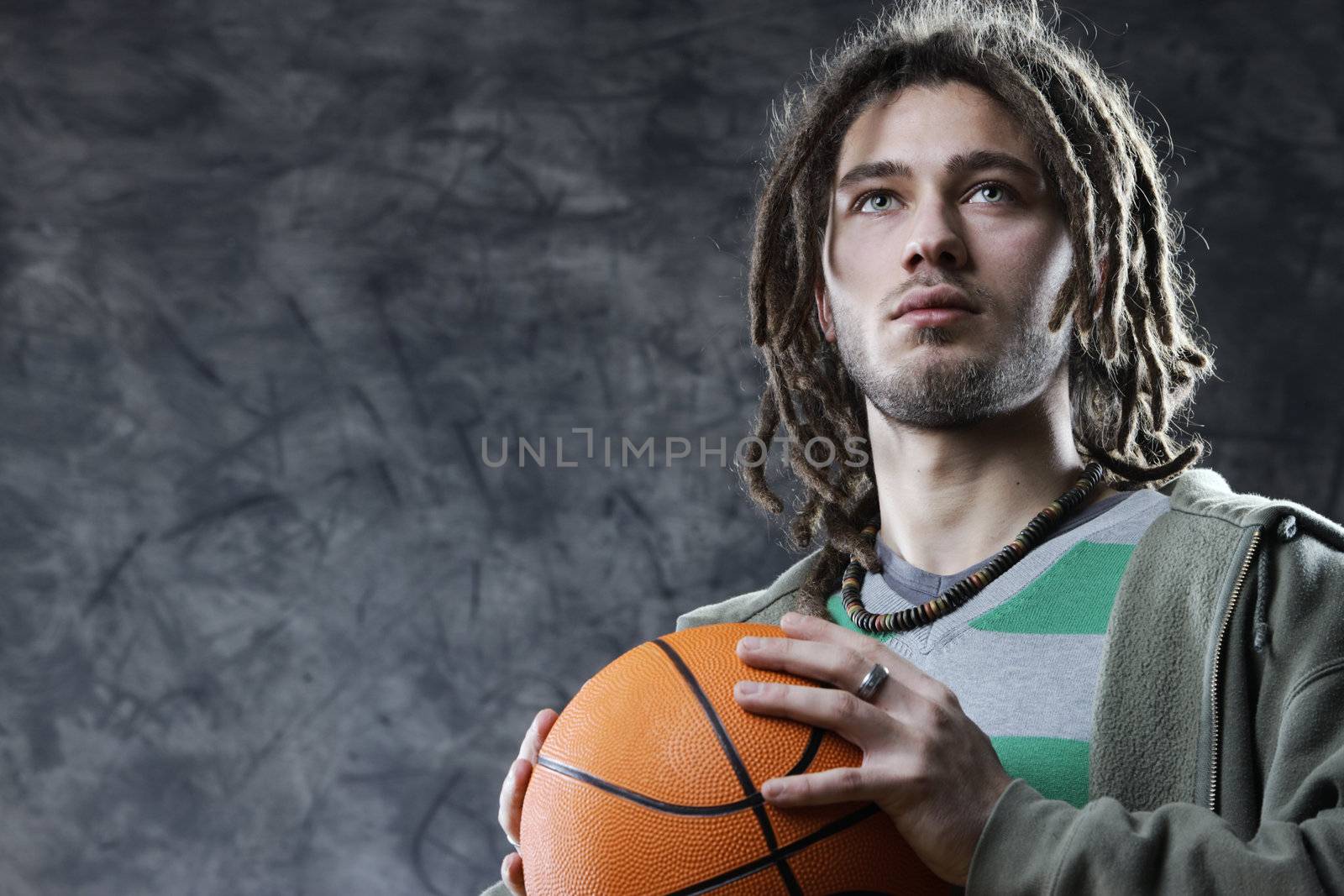 Portrait of young man with basketball