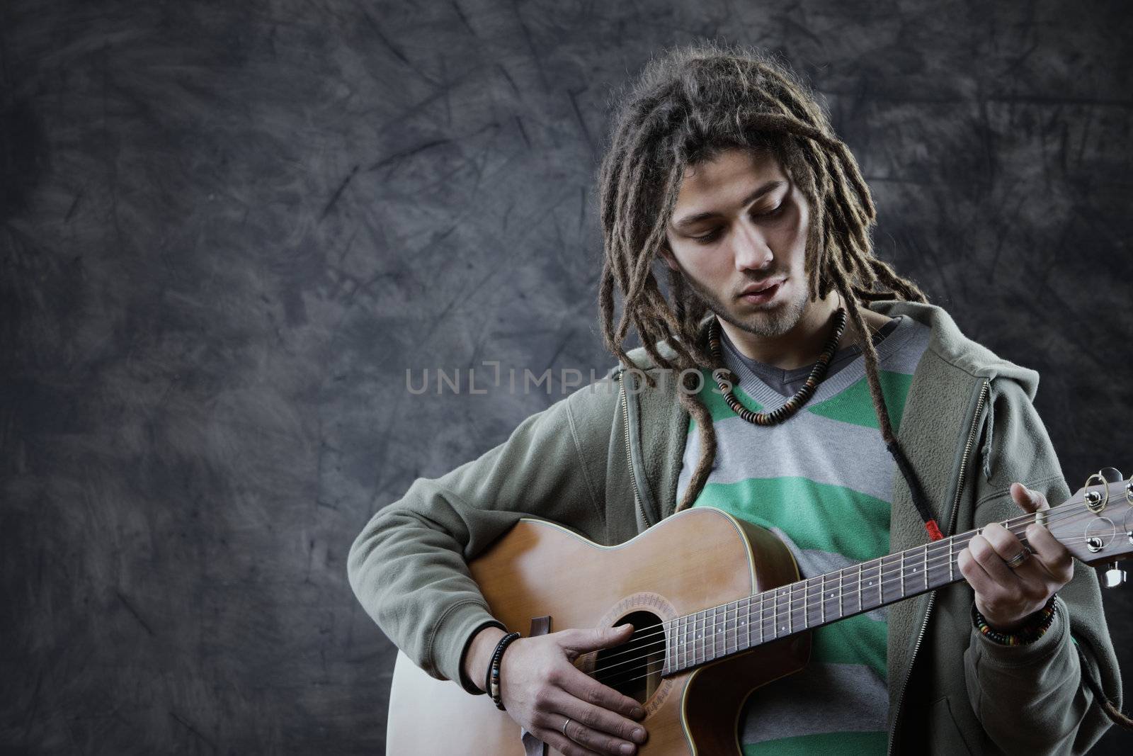Young man playing acoustic guitar