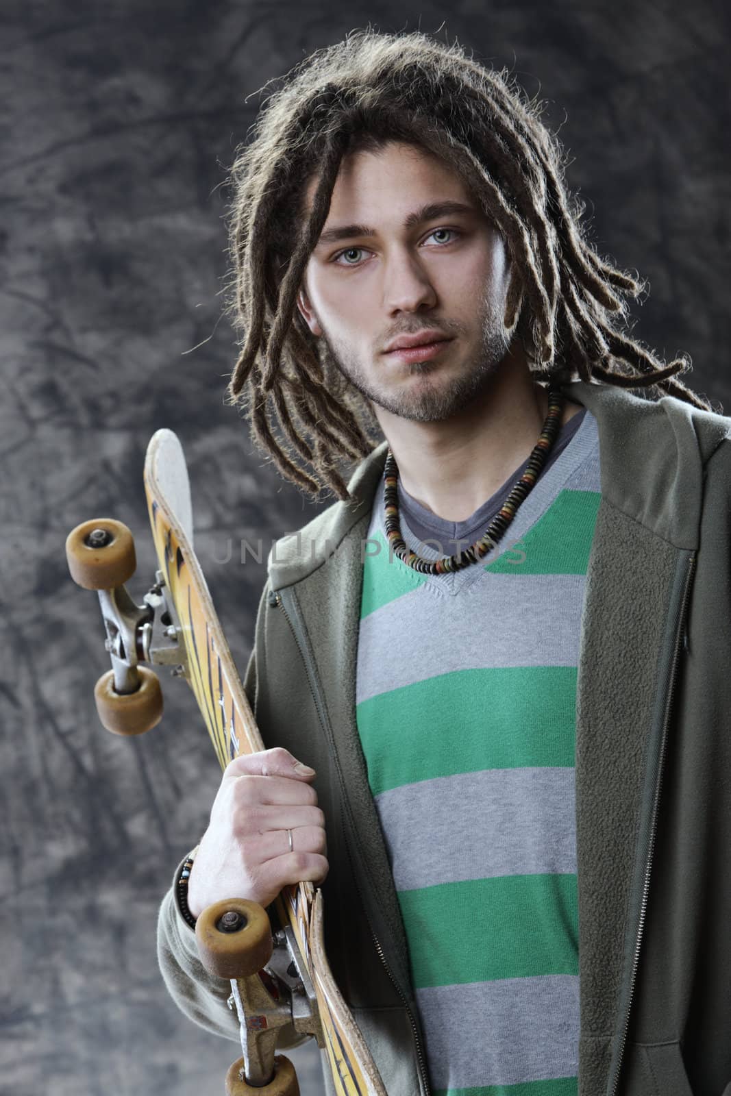 Portrait of young guy with a skateboard