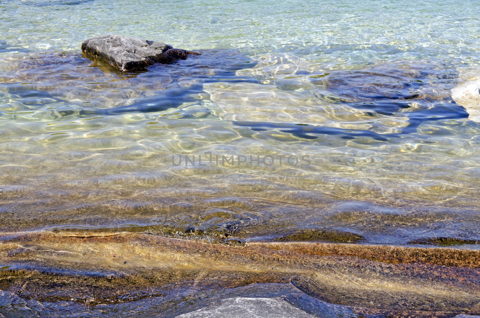 Rock under clear water at shore of Georgian Bay of Lake Huron Ontario