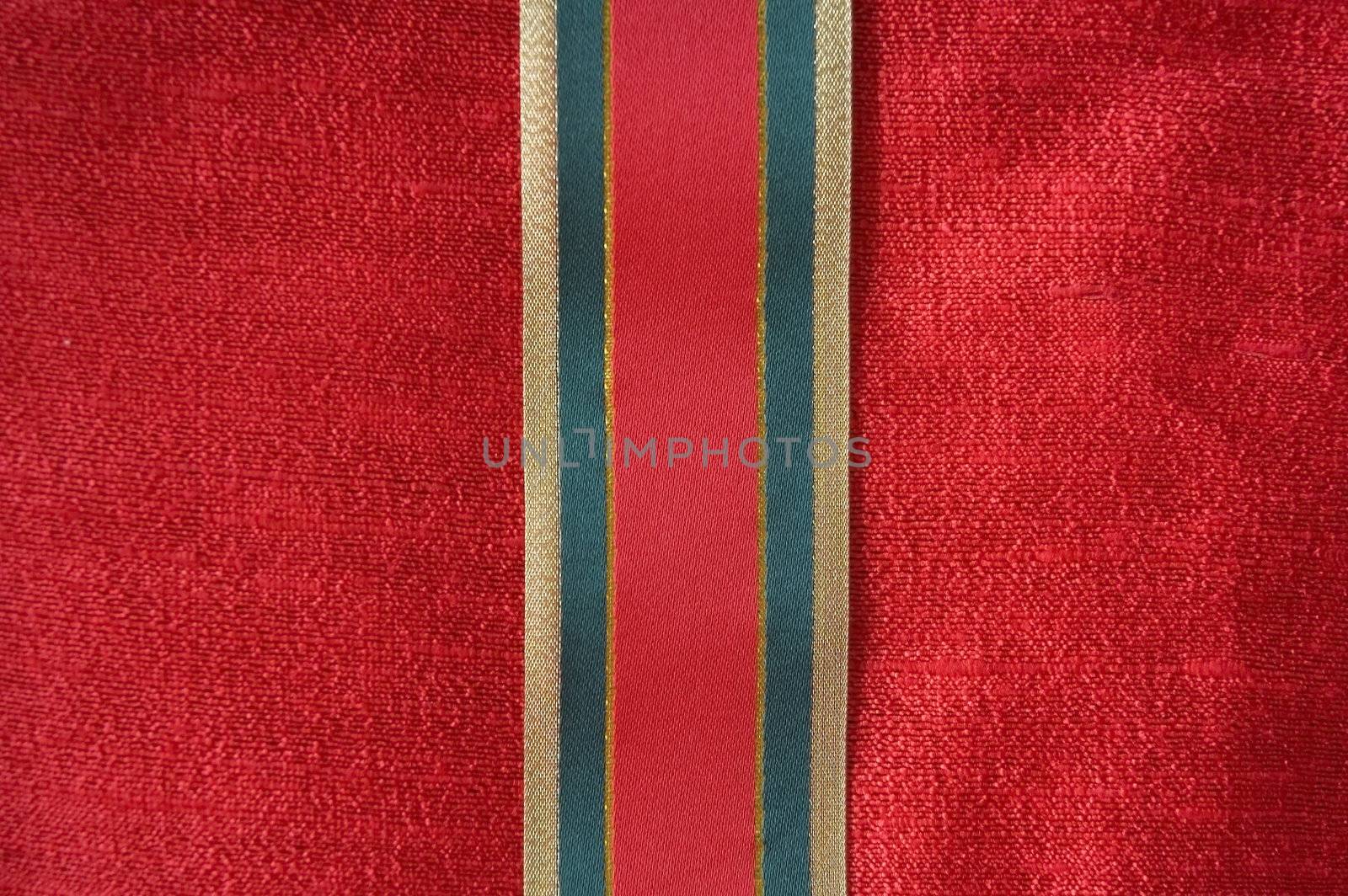 Christmas ribbon on red background.