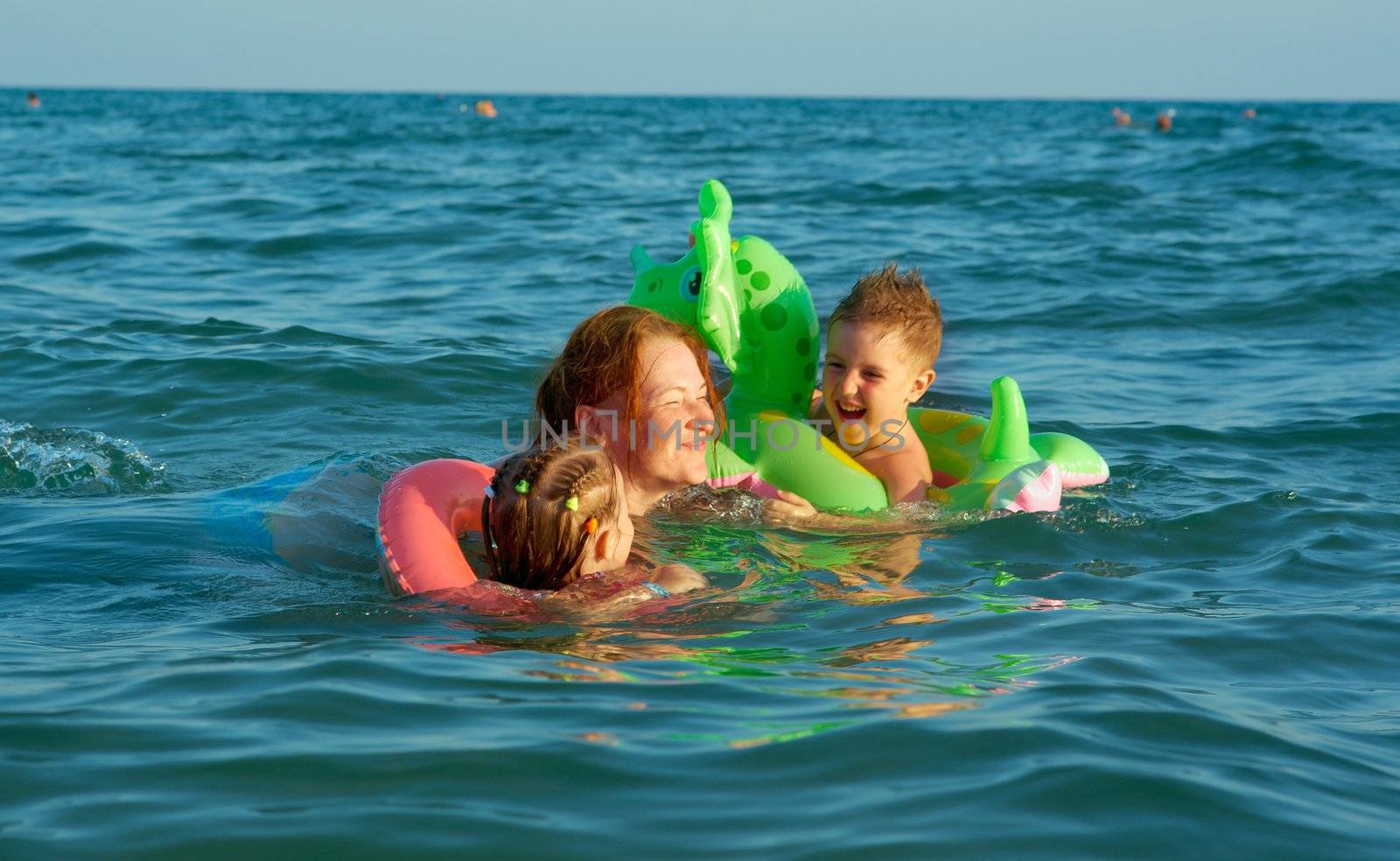 family in the waves on the sea beach