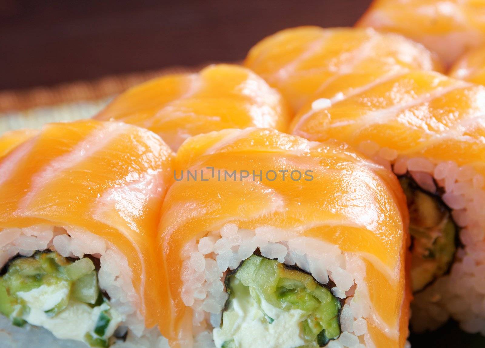 Uramaki. Philadelphia classic. Salmon, Philadelphia cheese, cucumber, avocado, tobiko. Japanese sushi