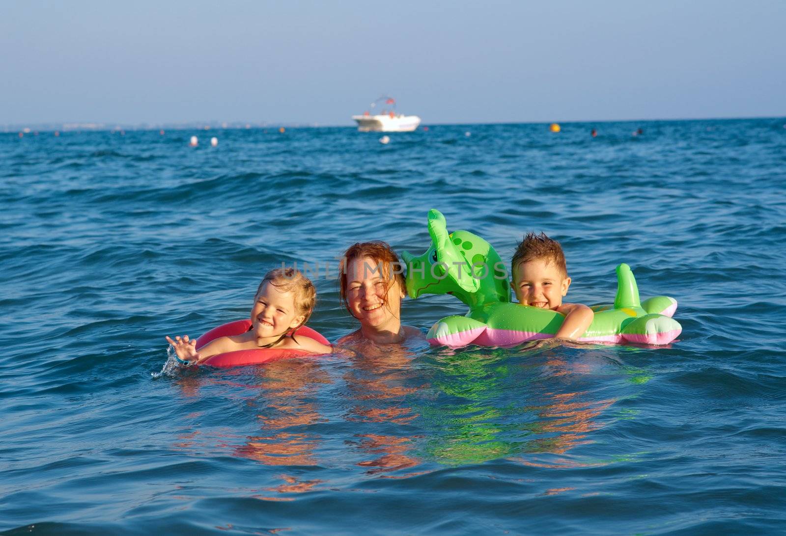 family in the waves on the sea beach