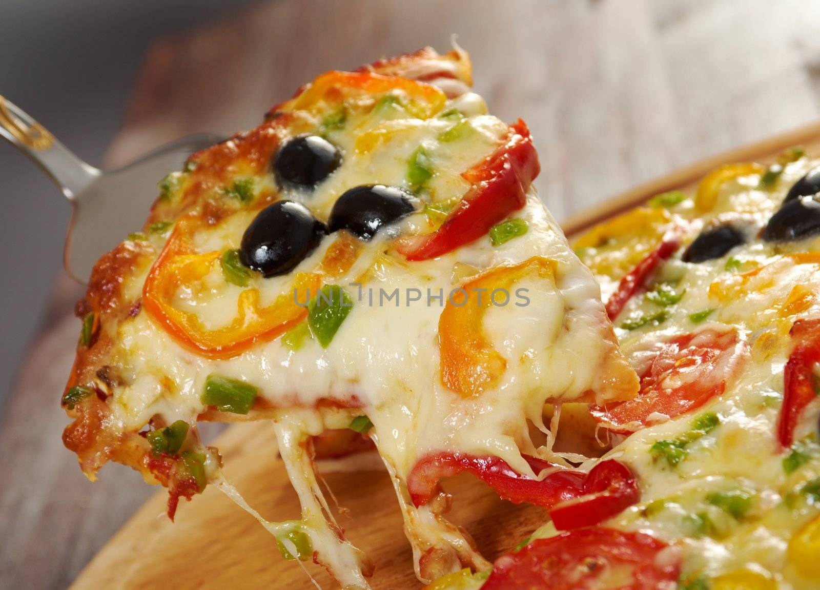 home pizza with tomato and eggplant  Closeup .taking slice of pizza,melted cheese dripping