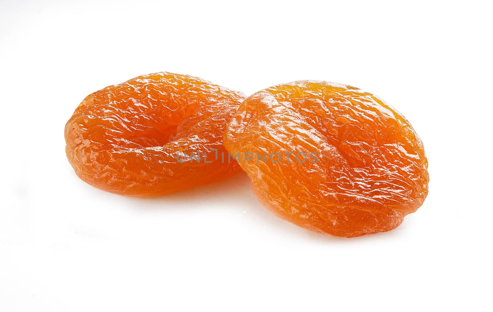Two orange isolated dried apricots on the white background