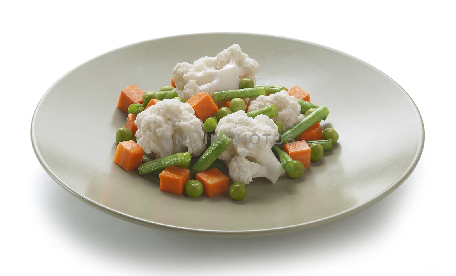 Vegetable mix with cauliflower, carrot, peas and kidney bean on the green plate
