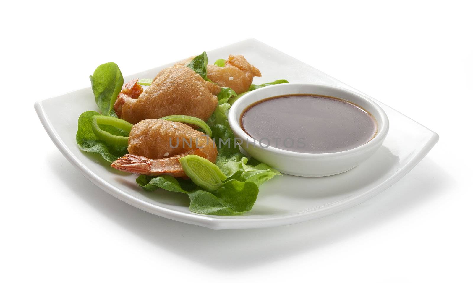 Shrimp tempura with lettuce, leek and soy sauce on the white palate