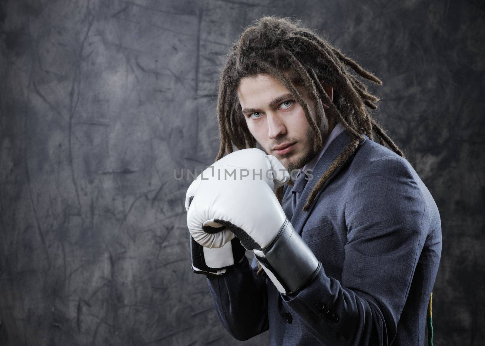 Businessman with boxe glove. Concept about the aggresivity of new business