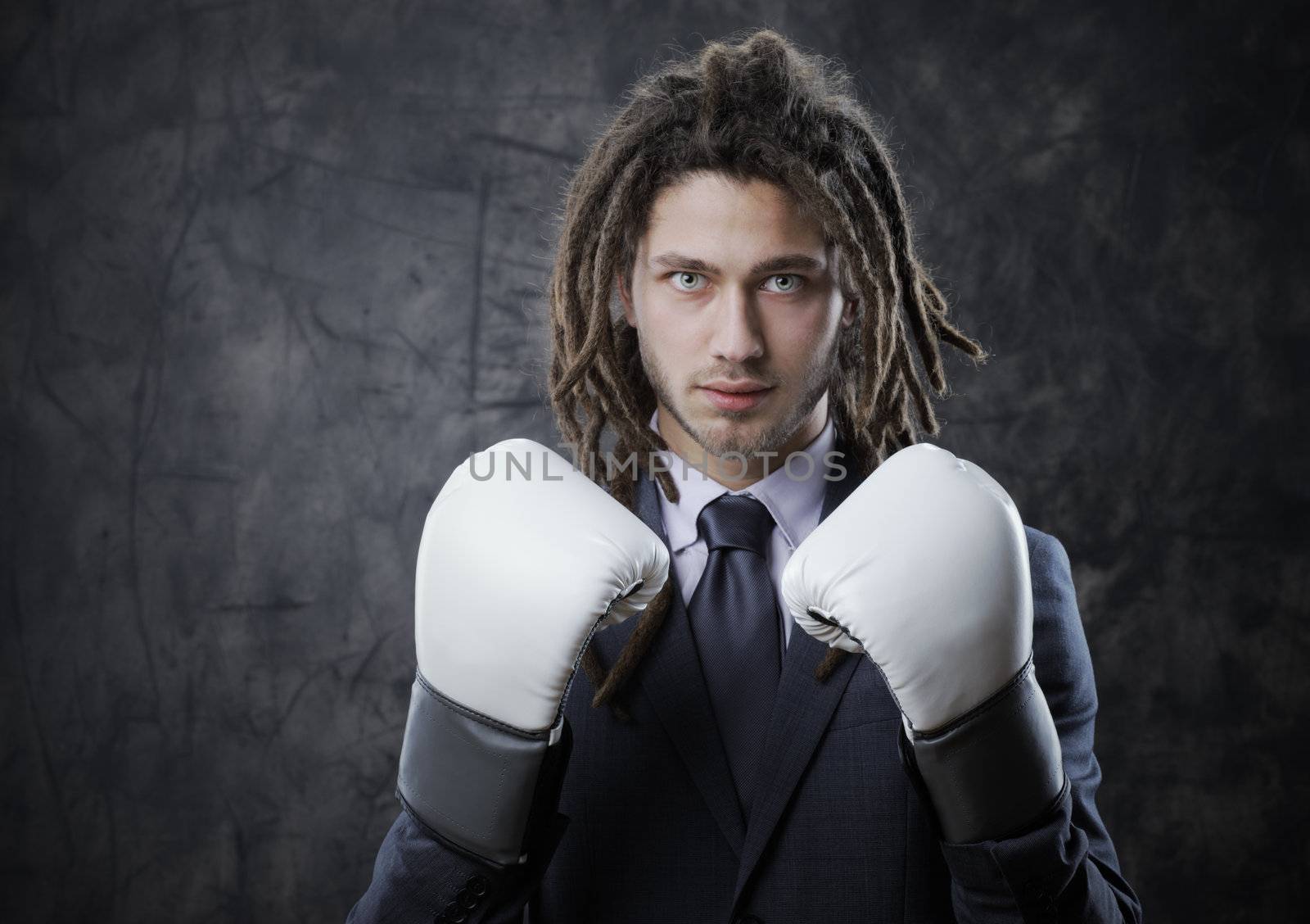 Businessman with boxe glove. Concept about the aggresivity of new business