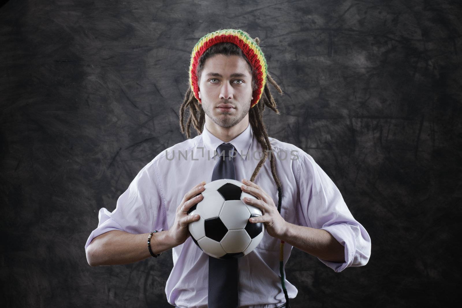 Portrait of a bizarre businessman with a soccer ball