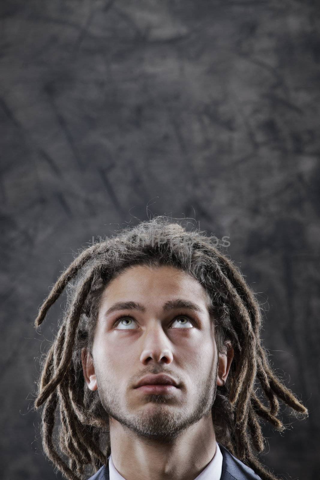 Young man looking up at copy space