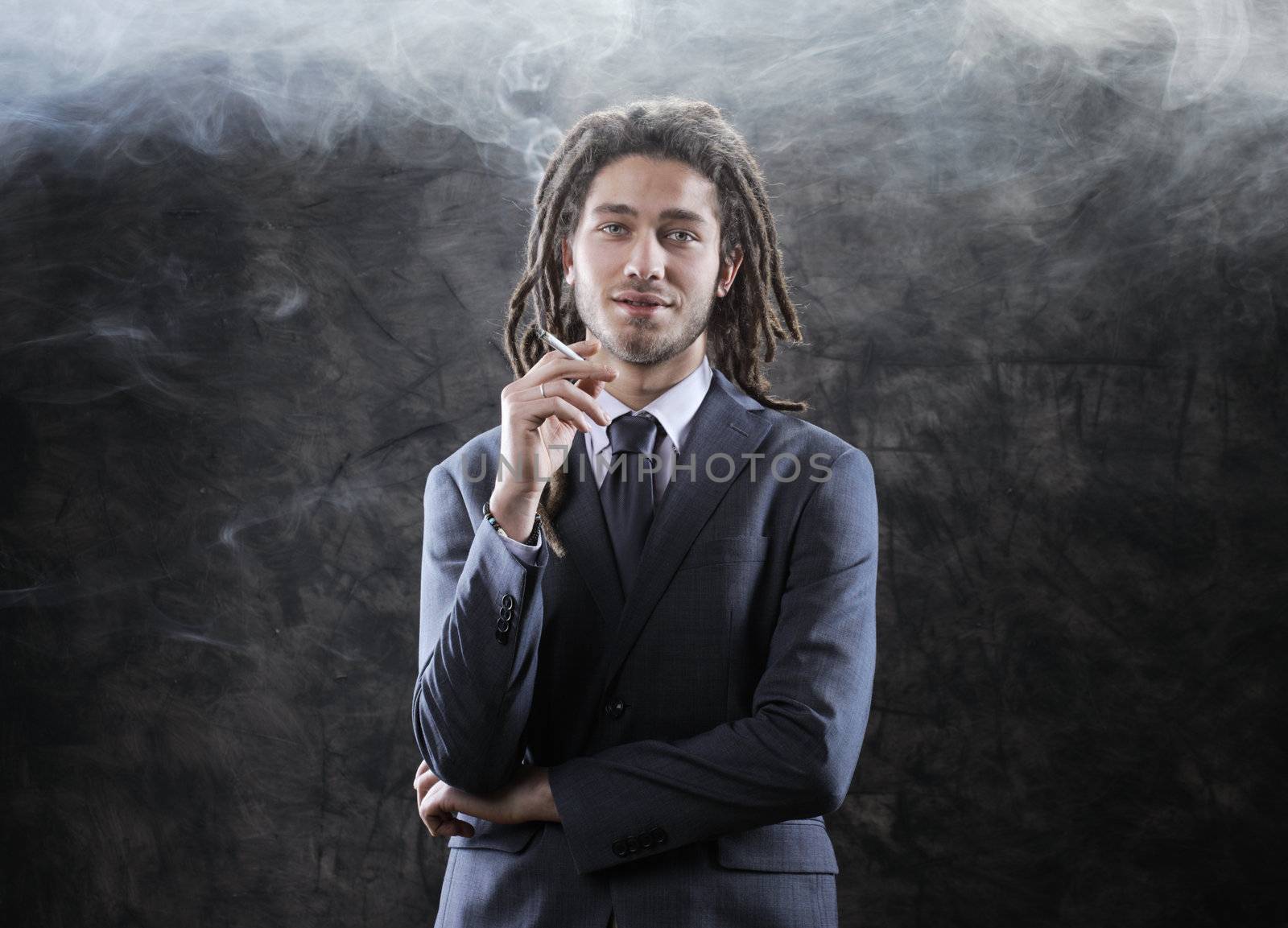 Rastafarian businessman smoking marijuana