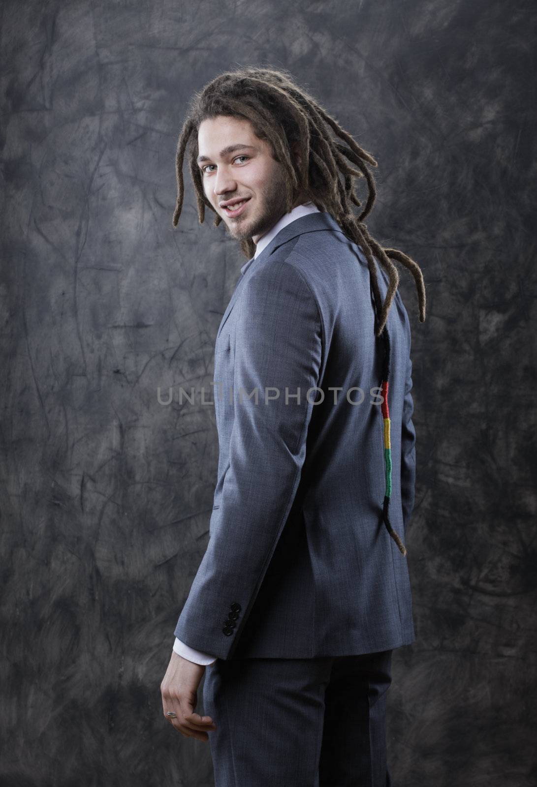 Portrait of positive well-dressed young businessman