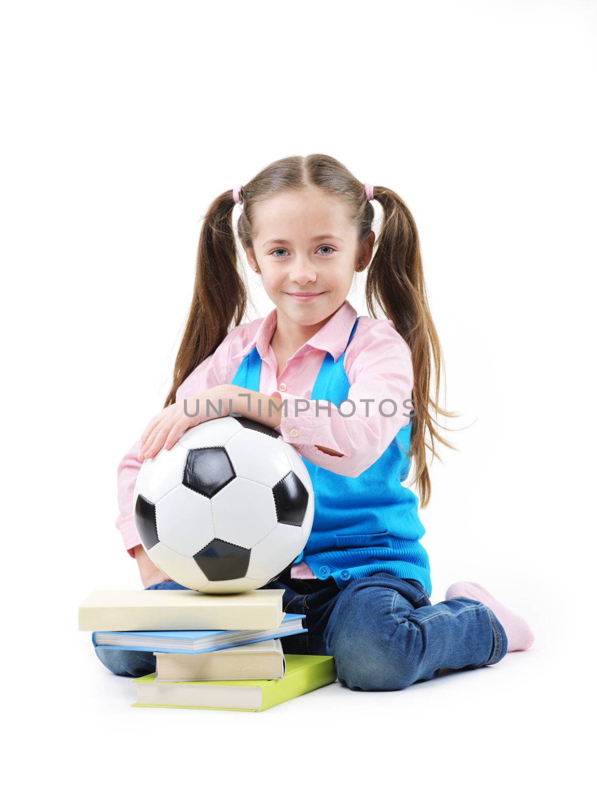 Cute little girl with books and soccer ball on white background