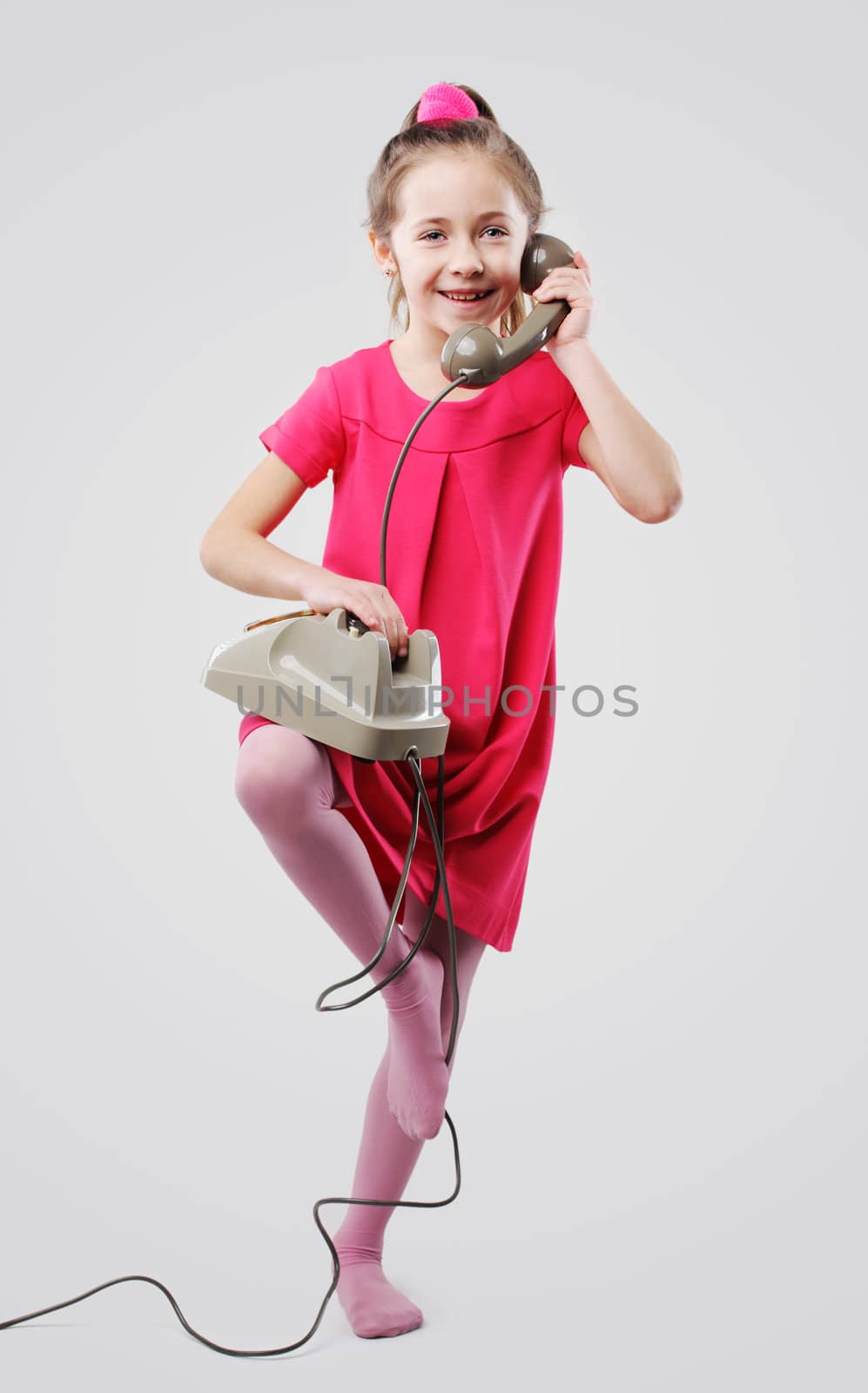 Cute young girls talking on vintage phone