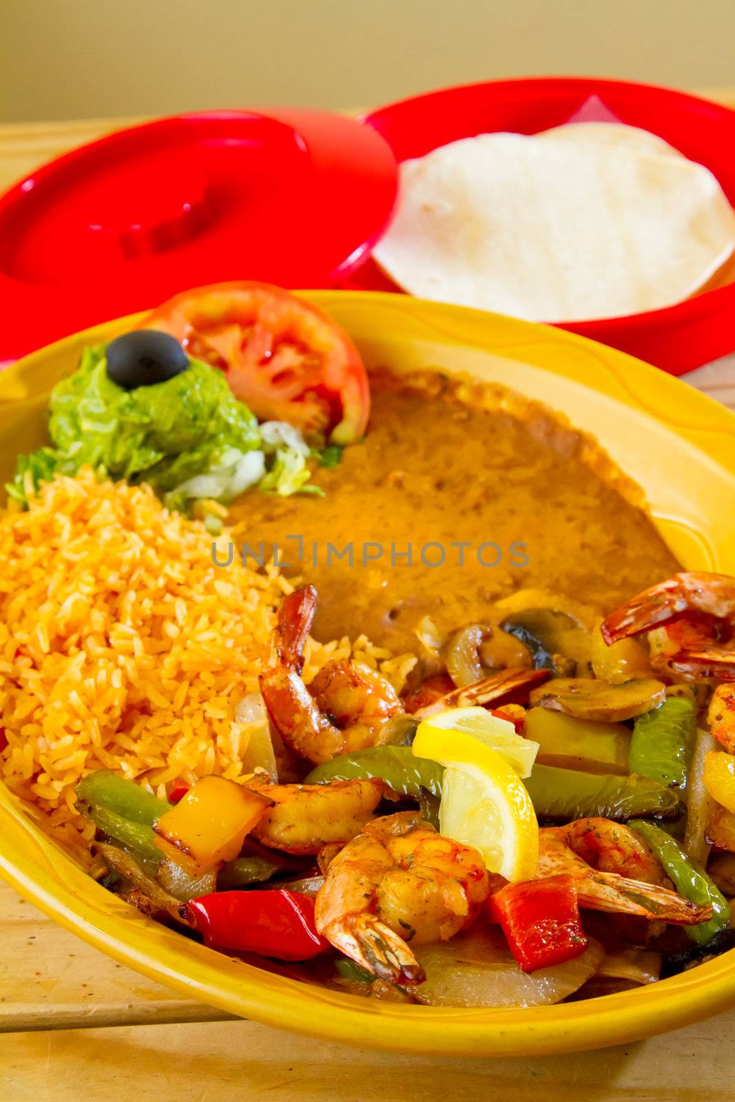 An authentic Mexican food restaurant has plated fajitas ready to serve.