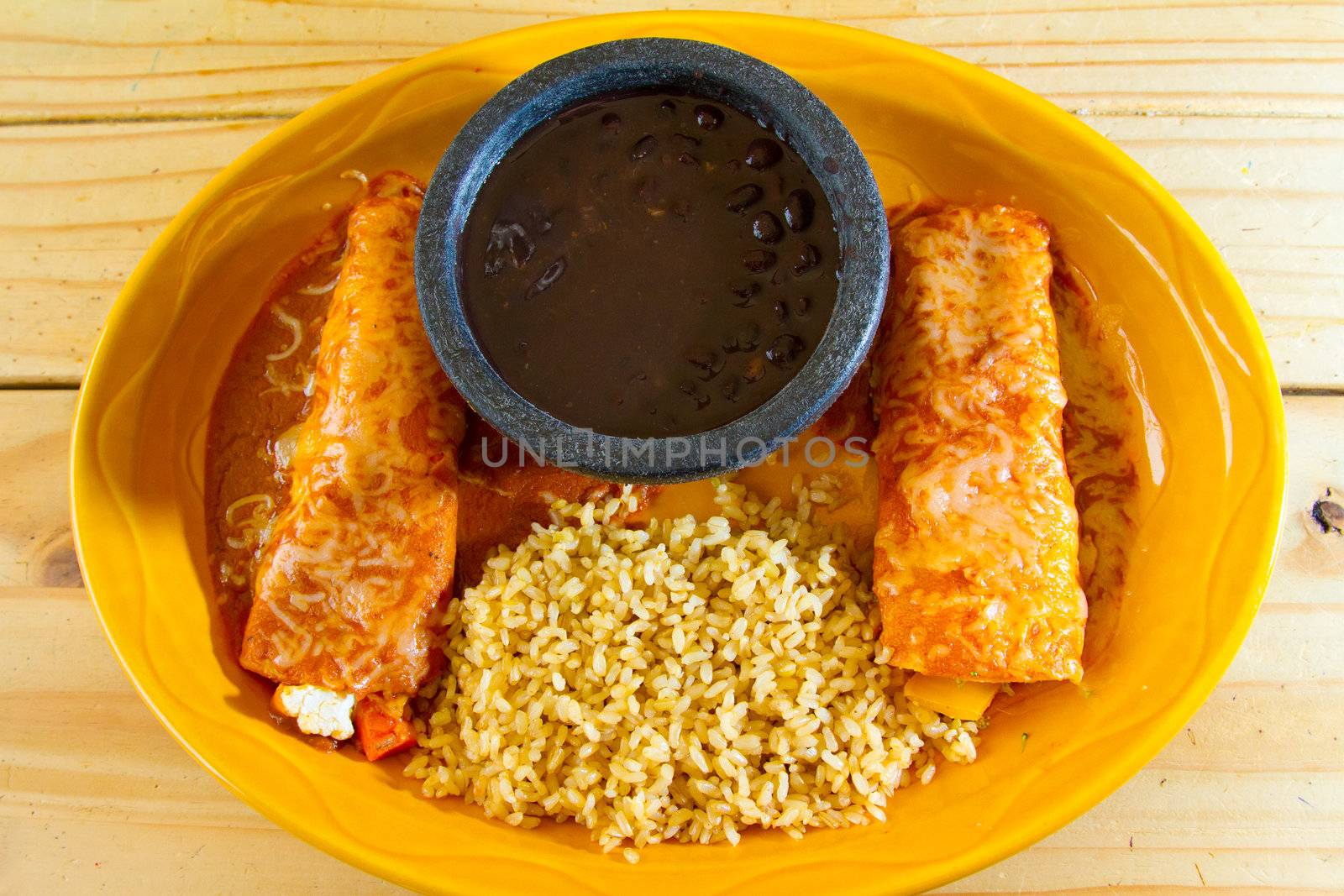 Enchiladas and rice and beans at a Mexican restaurant serving authentic cuisine.