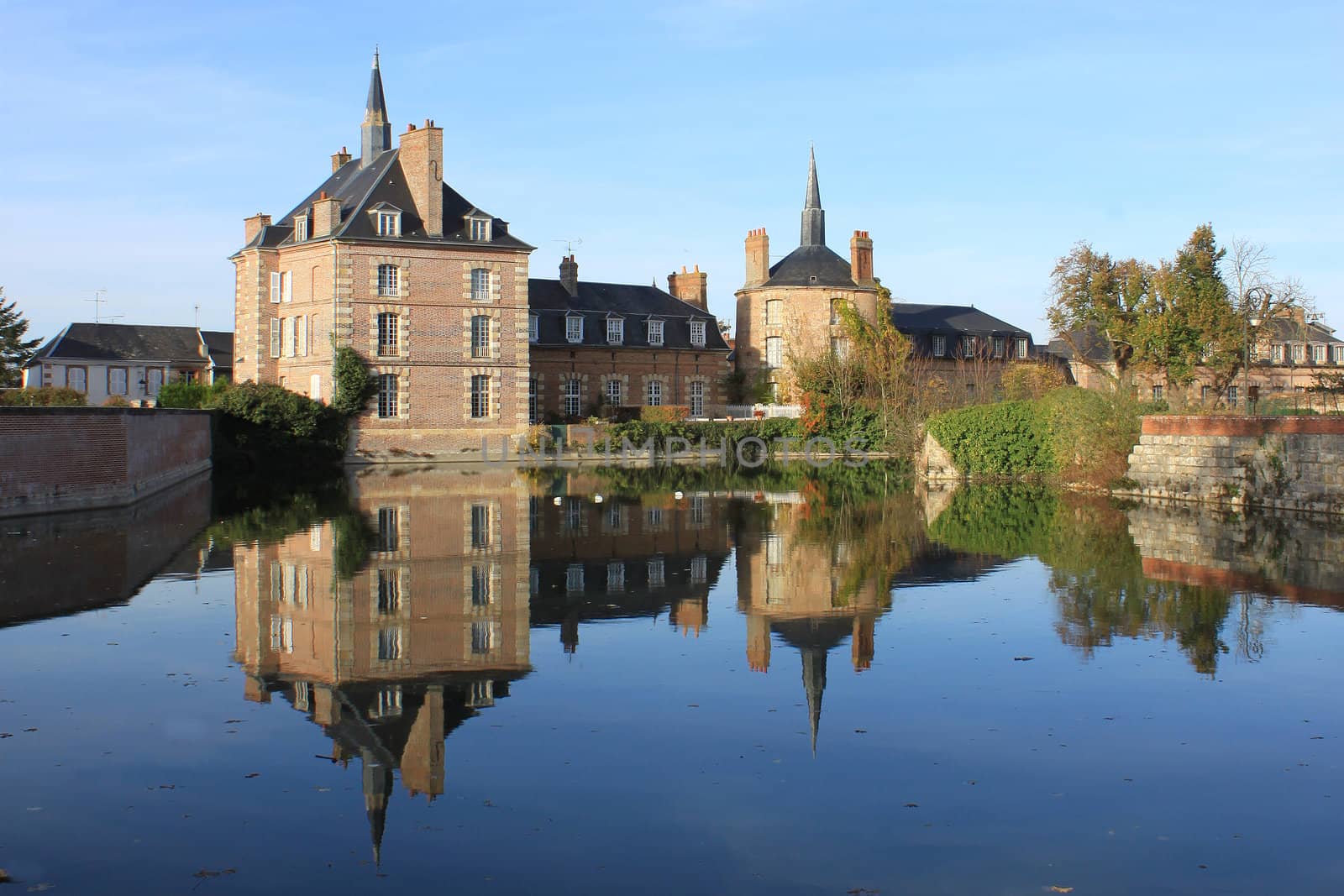 a castle with its moats, its park and garden with its towers and its ancient architecture