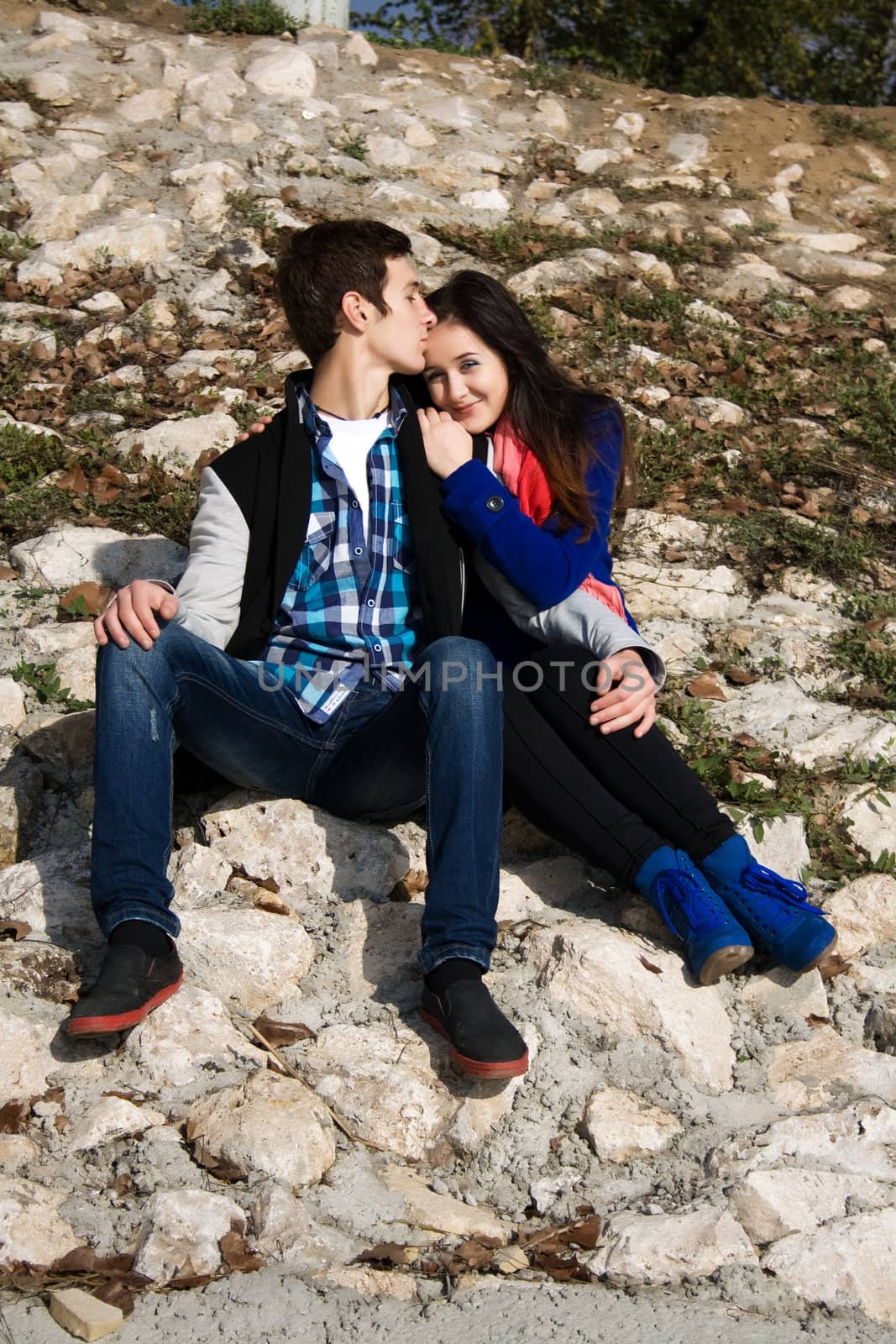 Teenagers Sitting by a street