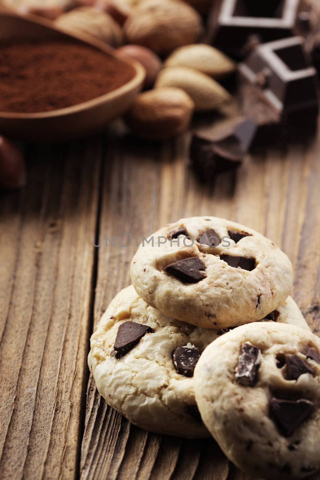 Chocolate chip cookies with ingredients in the background