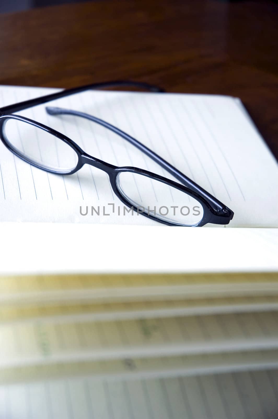 black frame eyeglasses put on notebook