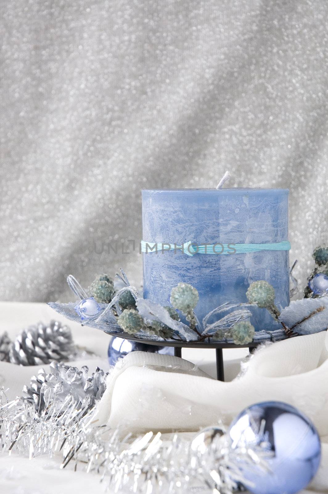 blue candle in winter moment decorated with ornaments