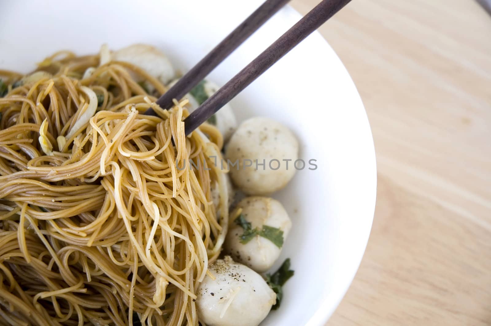 clsoe up chopstick on asian noodle