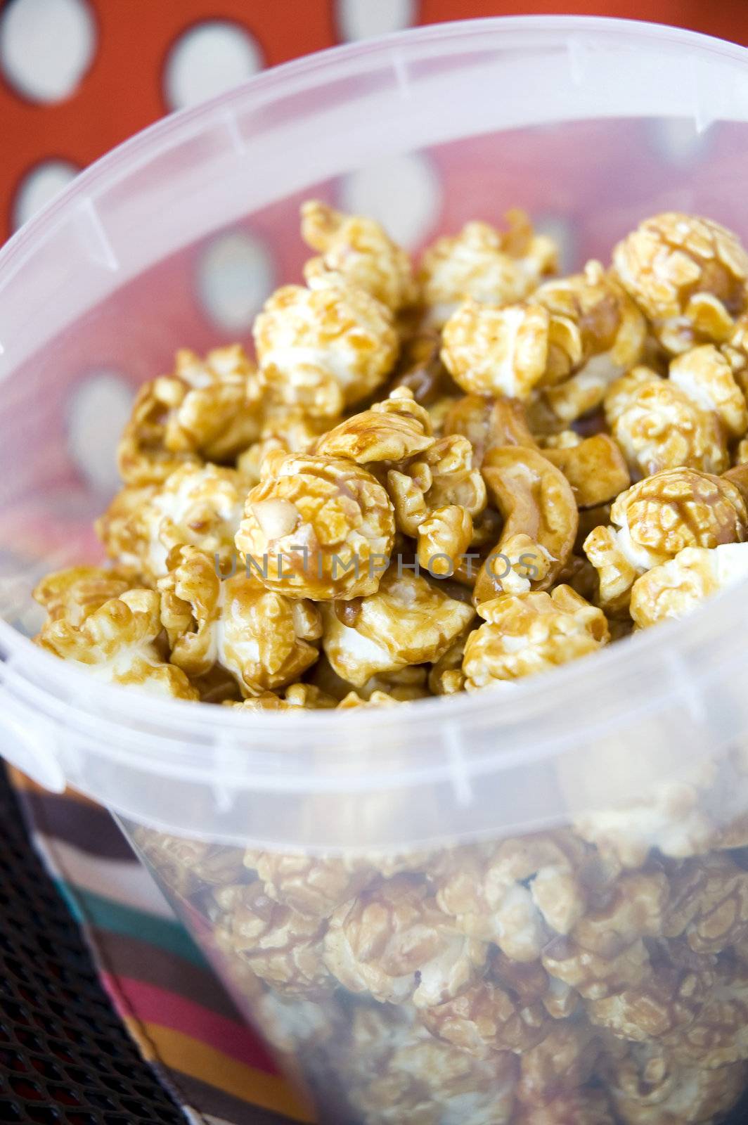 close up caramel popcorn in plastic bucket