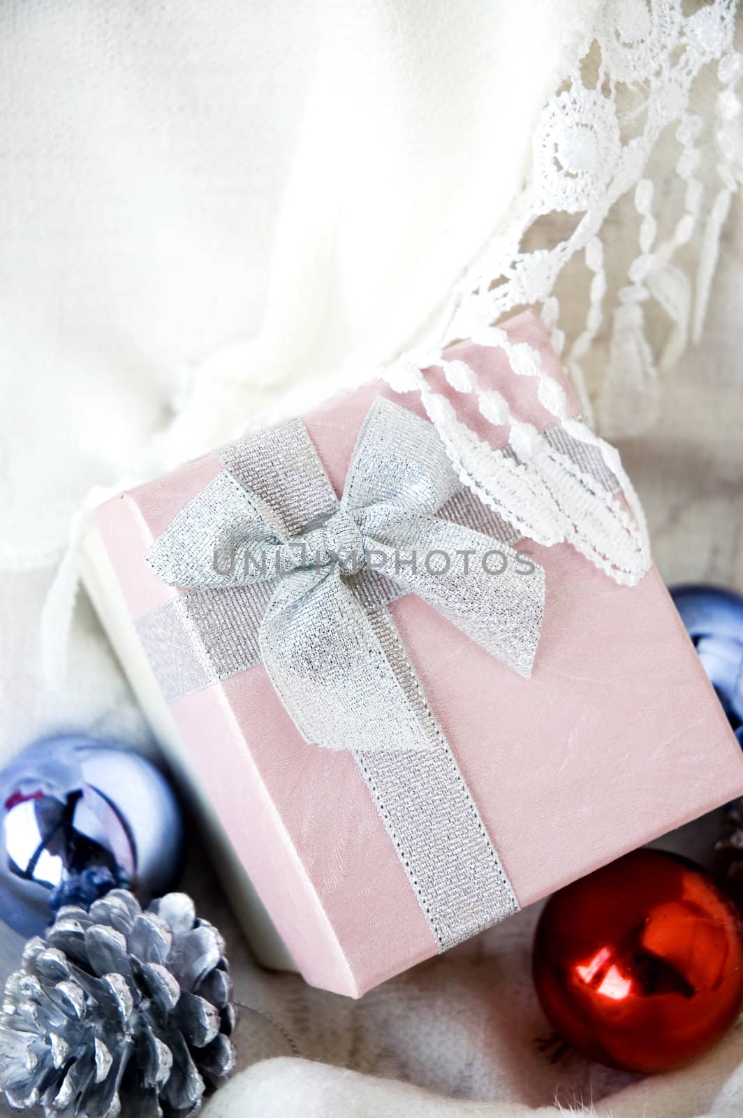 lovely gift box put on white clothing with christmas ornament