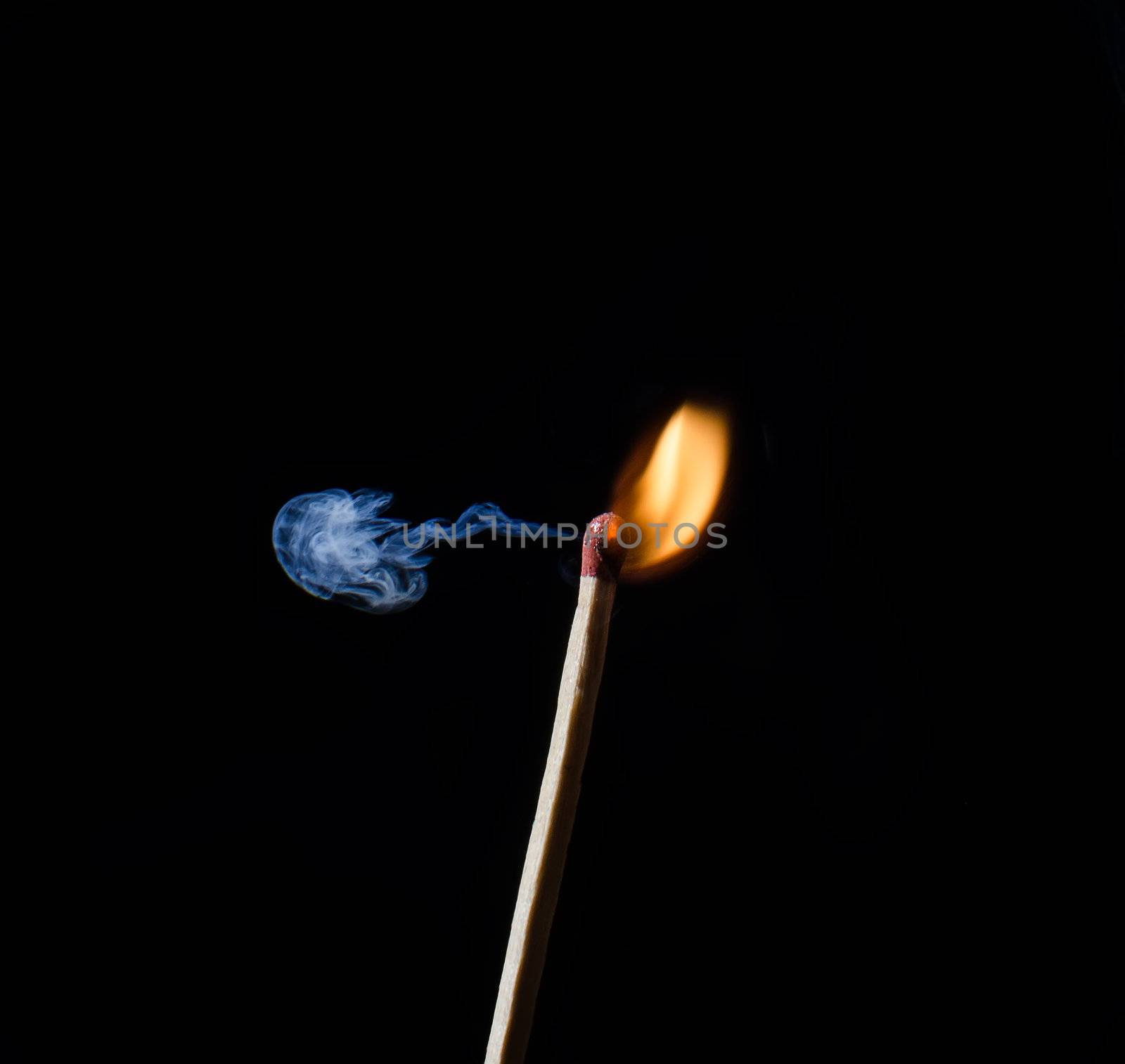 Match ignition with smoke over black background