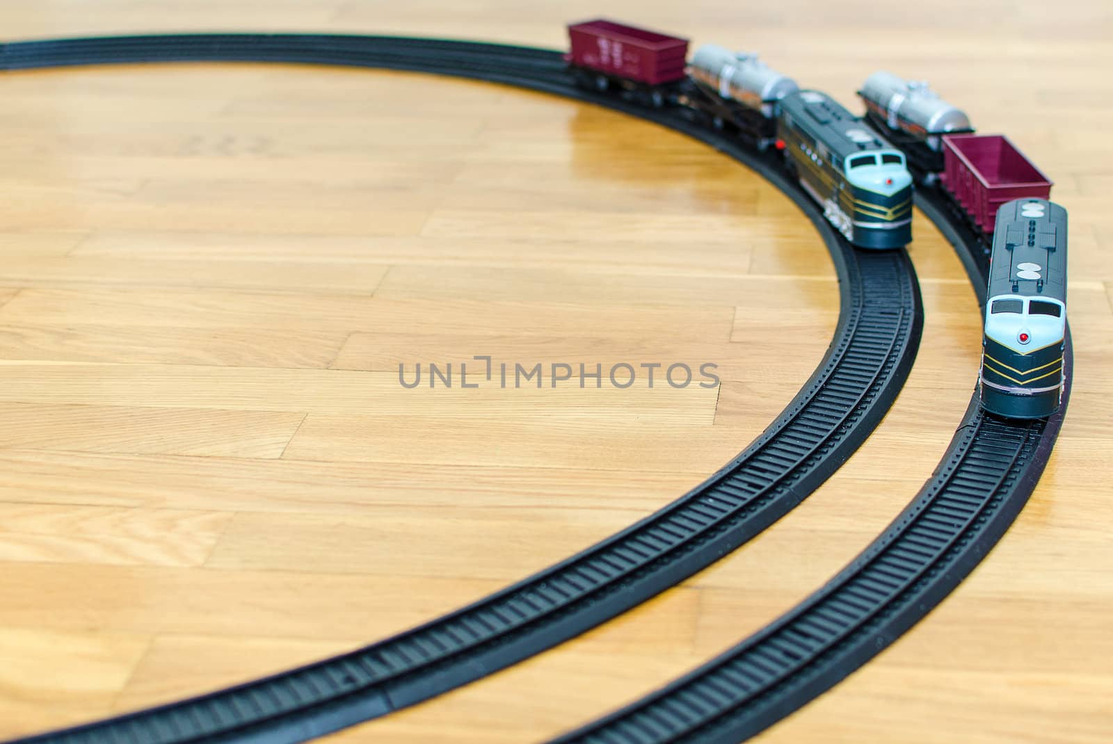 Two toy trains on wooden floor by dmitrimaruta